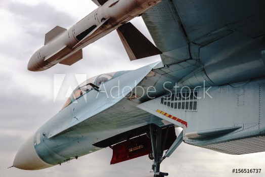 Picture of Fighter with missiles under the wing against the sky